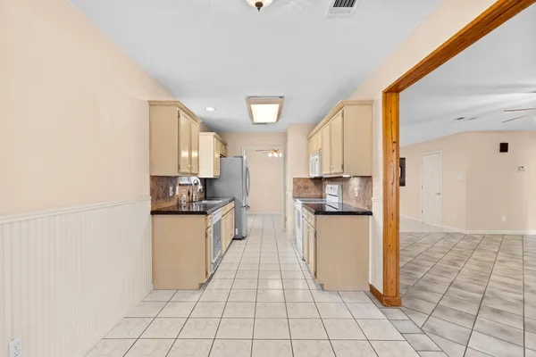 a kitchen with stainless steel appliances a refrigerator sink and stove