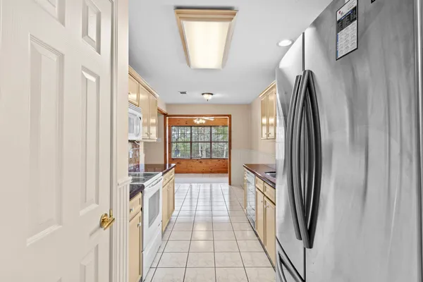 a view of a kitchen with a refrigerator and windows