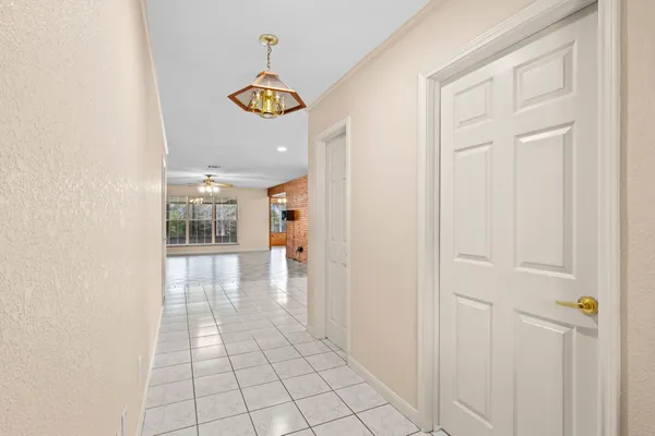 a view of a hallway with a chandelier