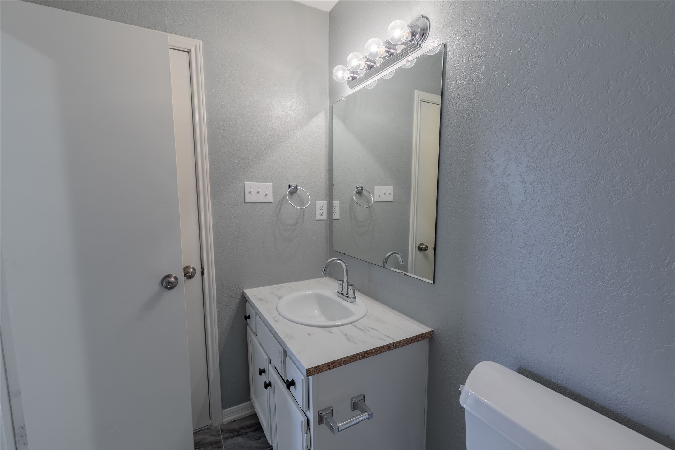 319 Rawhide Loop Round Rock, TX 78681 - Photo 24 of 28 Half bath with a textured wall and vanity