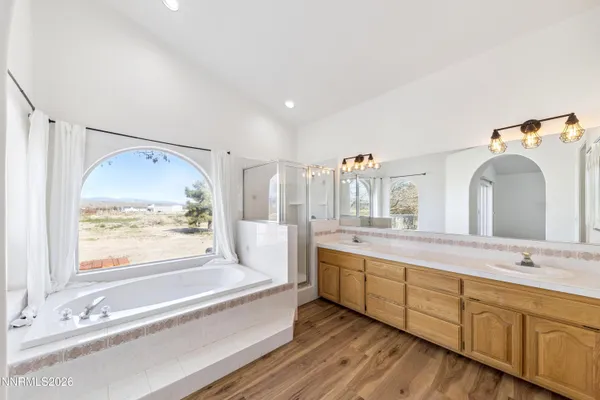 a spacious bathroom with a double vanity sink and a large mirror