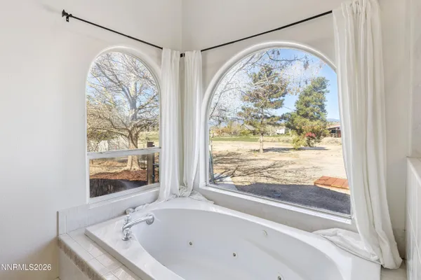 a bathroom with a bathtub and window