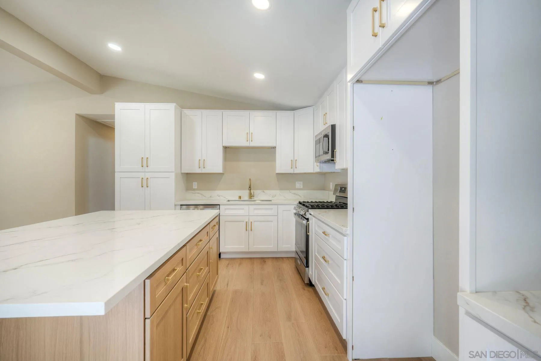 578 East Indian Rock Road Vista, CA 92084 - Photo 24 of 30 a kitchen with granite countertop white cabinets and white appliances