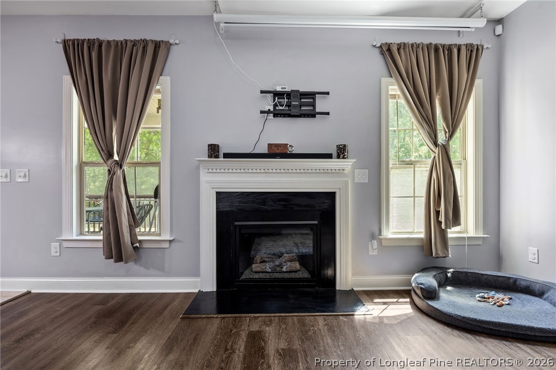 64 Cromwell Circle Cameron, NC 28326 - Photo 15 of 50 a living room with a fireplace furniture a large window and a wooden floor