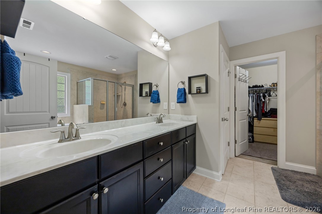 64 Cromwell Circle Cameron, NC 28326 - Photo 24 of 50 a spacious bathroom with a double vanity sink a mirror and a shower