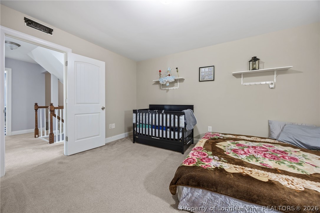 64 Cromwell Circle Cameron, NC 28326 - Photo 28 of 50 a bedroom with a bed and a chair