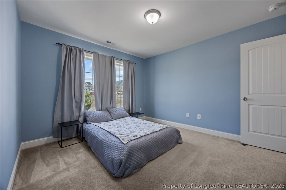 64 Cromwell Circle Cameron, NC 28326 - Photo 29 of 50 a bedroom with a bed and a window