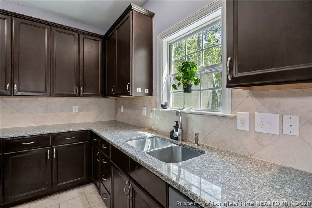 64 Cromwell Circle Cameron, NC 28326 - Photo 3 of 50 a kitchen with granite countertop a sink window and cabinets