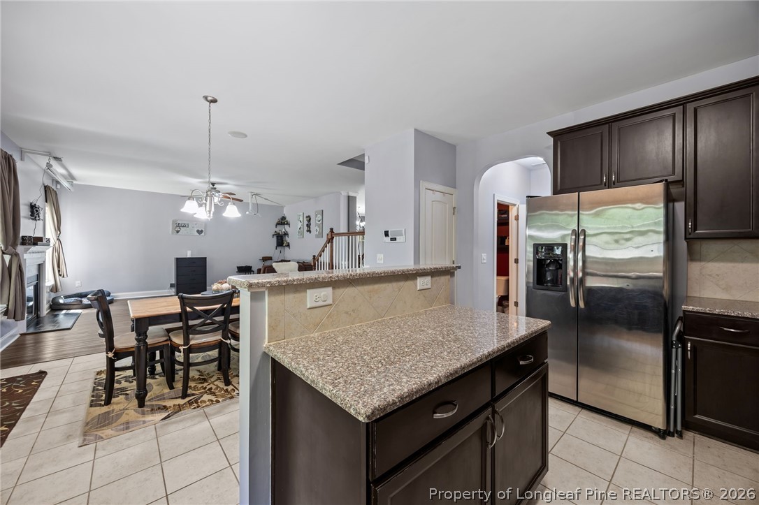 64 Cromwell Circle Cameron, NC 28326 - Photo 4 of 50 a kitchen with stainless steel appliances granite countertop a table chairs and refrigerator