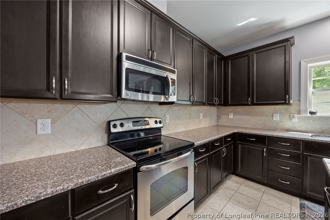 64 Cromwell Circle Cameron, NC 28326 - Photo 5 of 50 a kitchen with granite countertop stainless steel appliances and cabinets