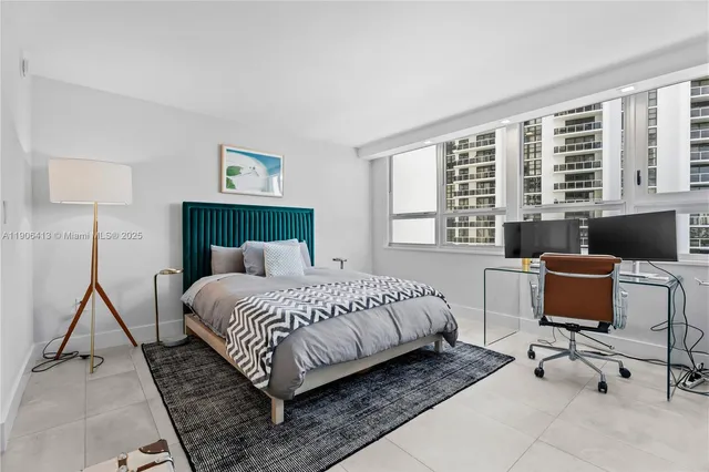 a bedroom with a bed a desk and chair