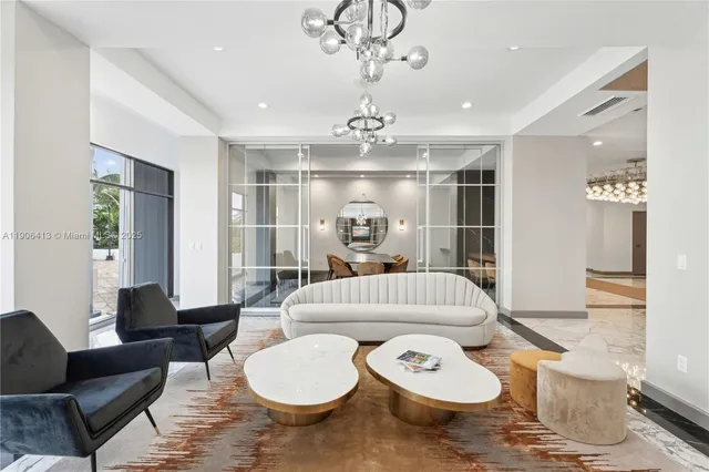 a living room with furniture and a chandelier
