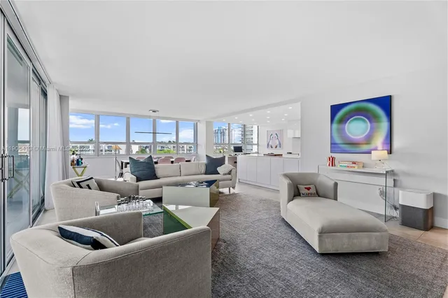 a living room with furniture and a painting on the wall