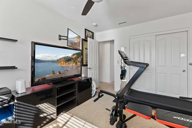 a room with gym equipment and windows
