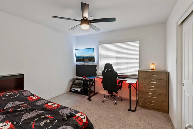 a view of a workspace with furniture and a window
