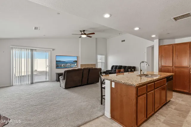 a kitchen that has a sink a stove and a refrigerator