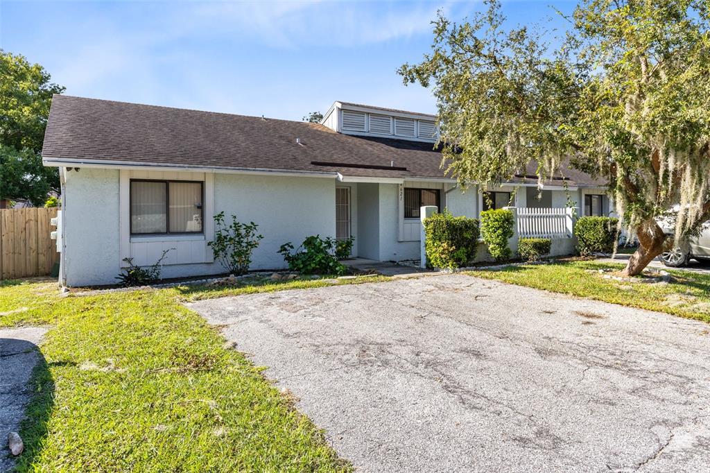 4621 North Pine Hills Road, Unit 113 Orlando, FL 32808 - Photo 1 of 1 a front view of a house with garden