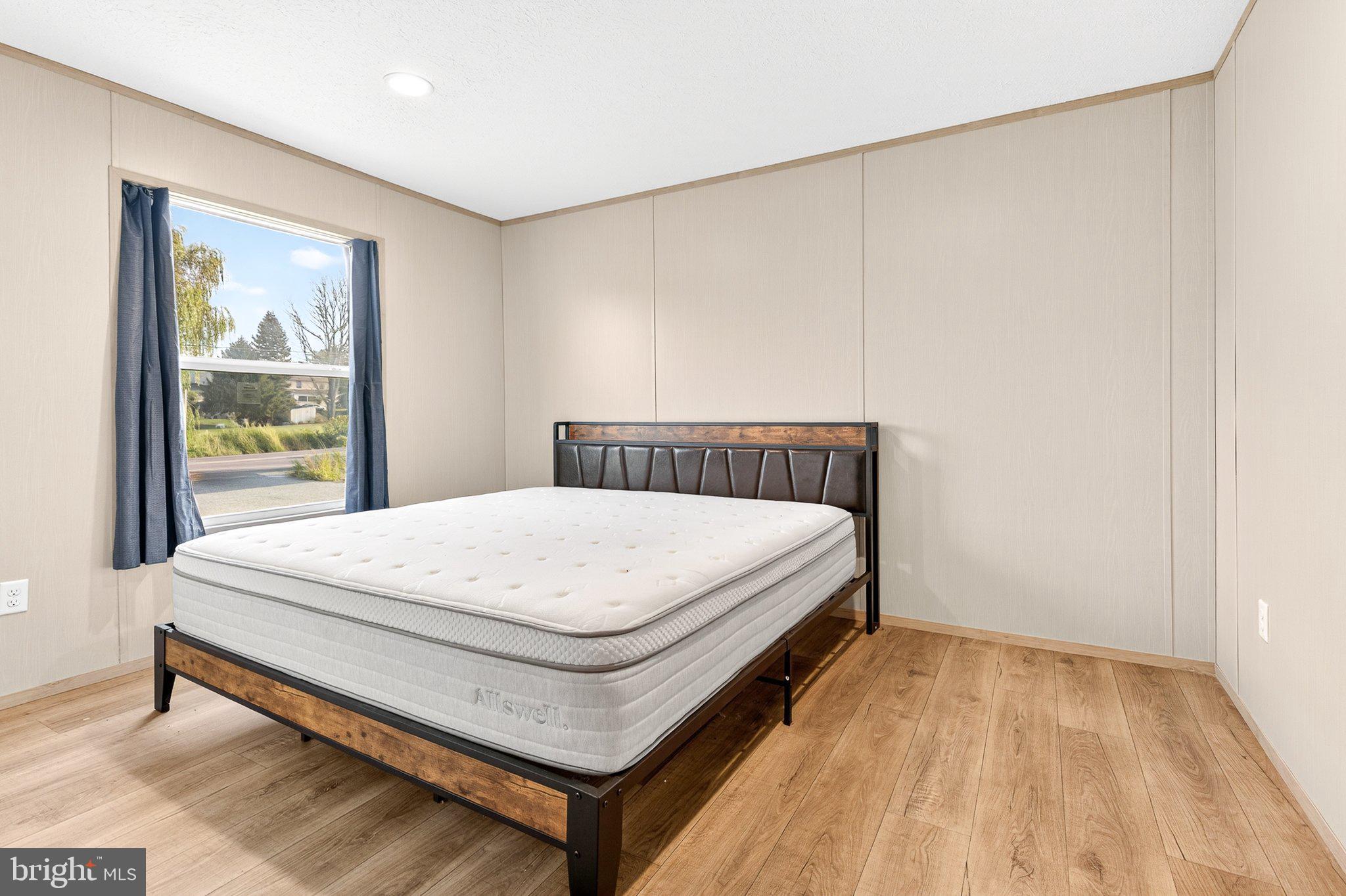 342 Frogtown Road Pequea, PA 17565 - Photo 14 of 37 a bed sitting in a bedroom next to a window