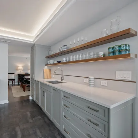 a kitchen with kitchen island a sink stainless steel appliances and cabinets
