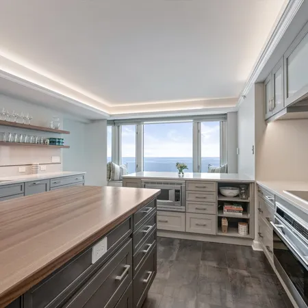 a kitchen with a sink a stove and cabinets