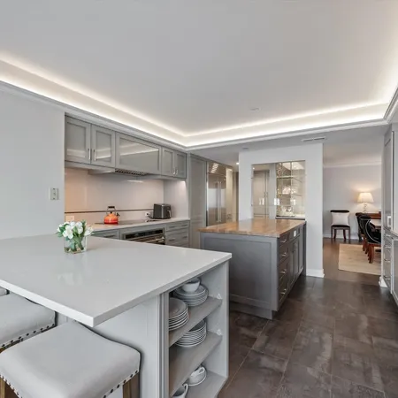 a kitchen with a sink a stove and chairs