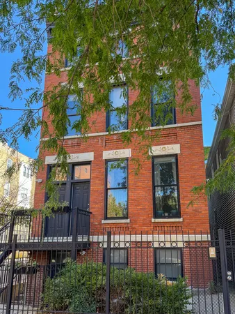 front view of a house with a tree