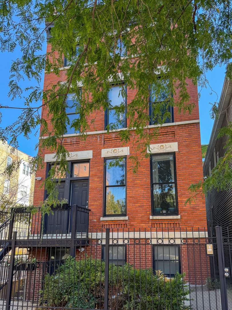 front view of a house with a tree
