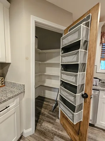 a view of walk in closet with empty racks