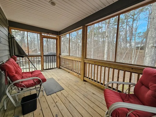 a living room with furniture a large window with wooden floor