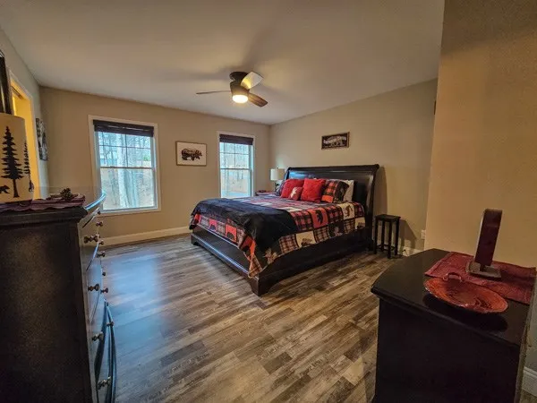 a bedroom with a bed and wooden floor