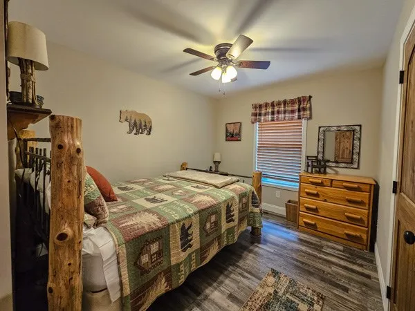 a bedroom with bed and a chandelier