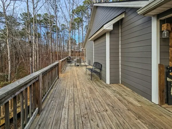 a view of a wooden deck besides a house
