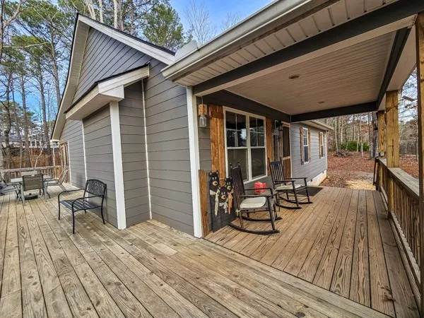 a porch with seating space and wooden floor