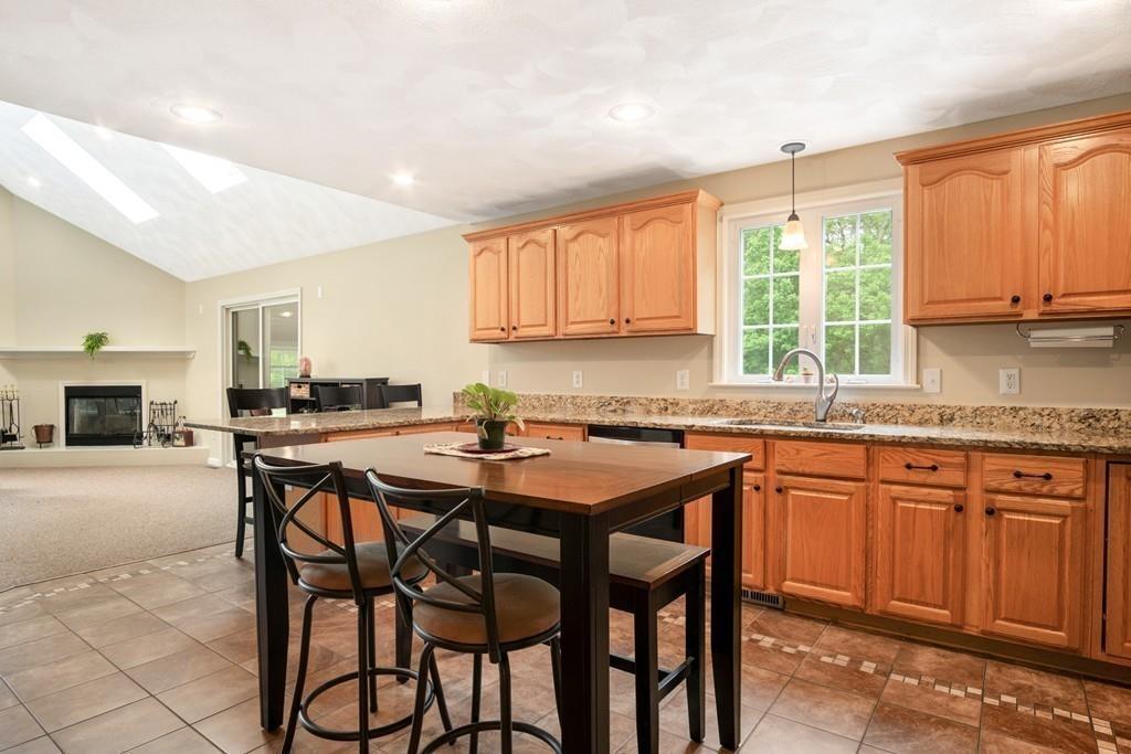 112 Weldon Farm Road Rowley, MA 01969 - Photo 13 of 33 a kitchen with granite countertop wooden cabinets a counter top space and a sink