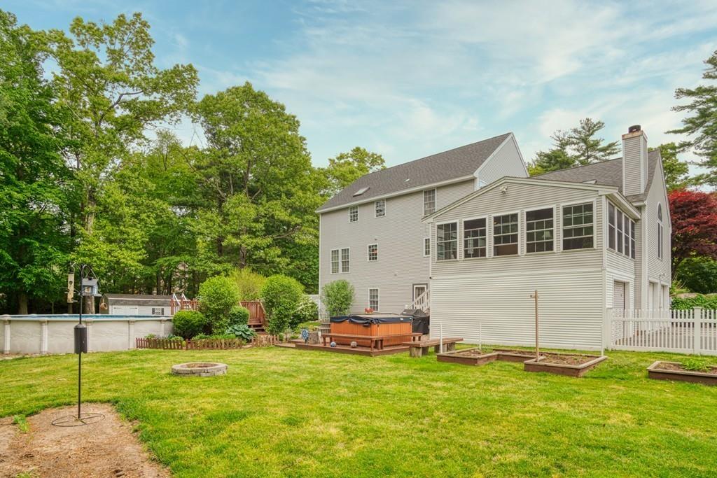 112 Weldon Farm Road Rowley, MA 01969 - Photo 25 of 33 a view of a white house with a yard table and chairs