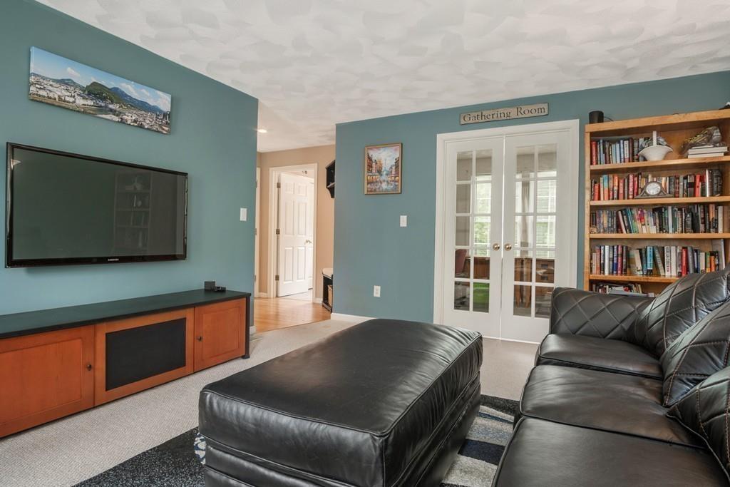 112 Weldon Farm Road Rowley, MA 01969 - Photo 10 of 33 a living room with furniture and a flat screen tv