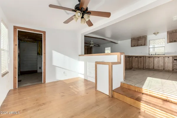 a view of a kitchen with furniture and a ceiling fan