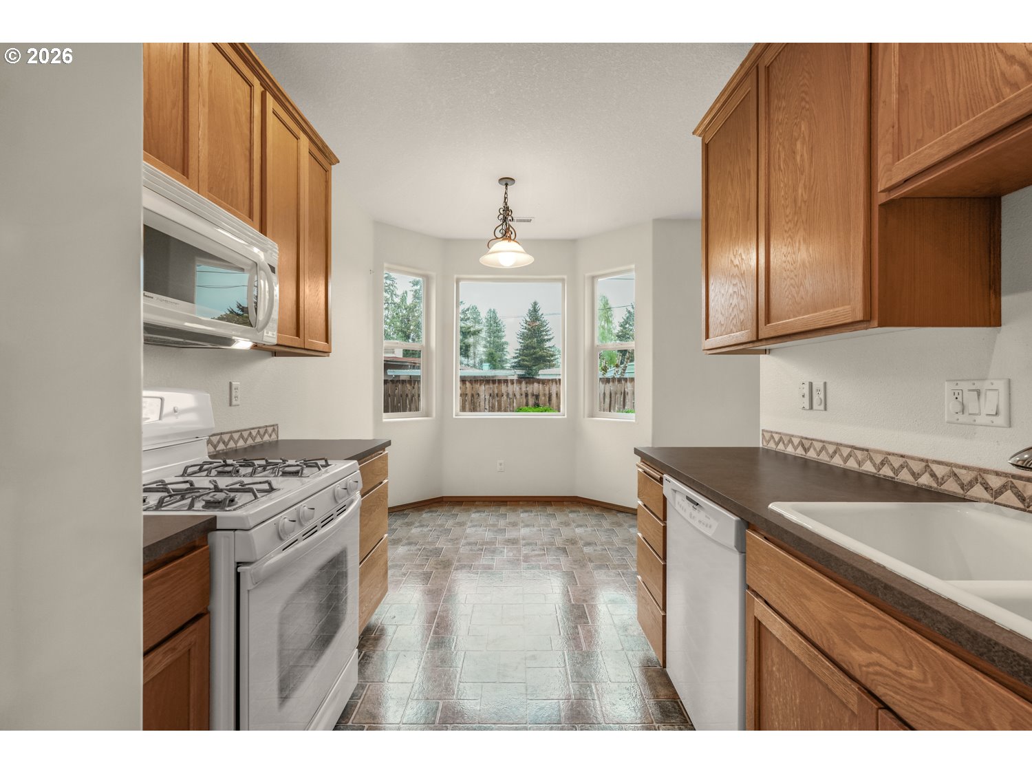 52234 Southeast Tyler Street Scappoose, OR 97056 - Photo 11 of 30 a kitchen with stainless steel appliances granite countertop a sink stove and cabinets