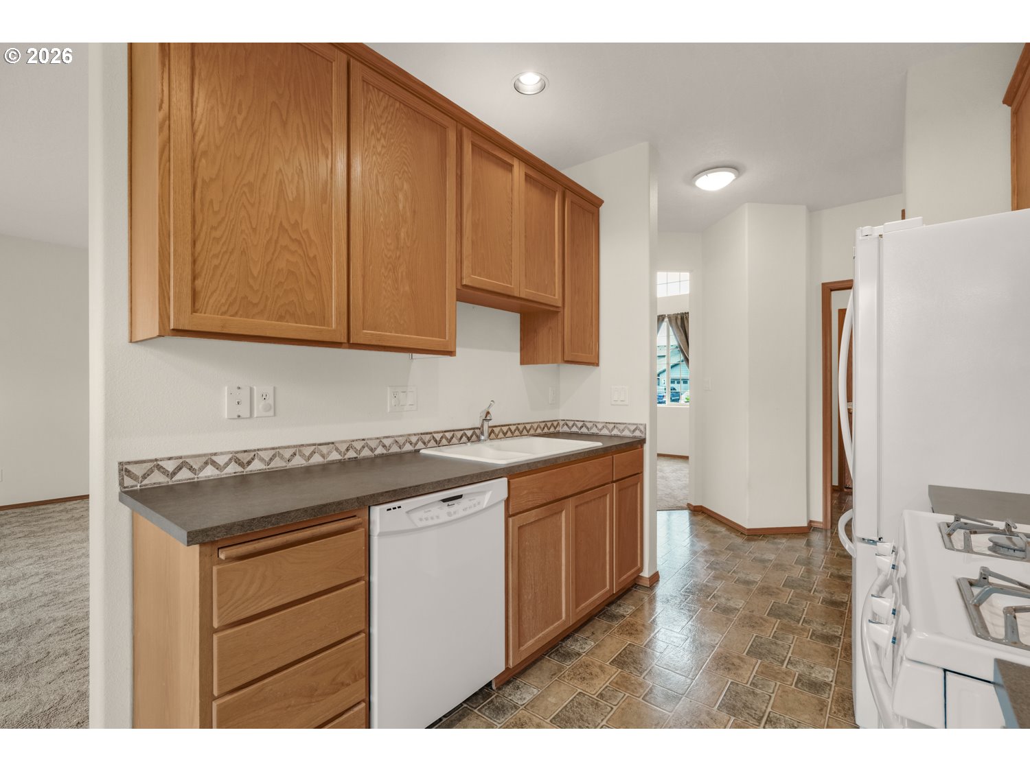 52234 Southeast Tyler Street Scappoose, OR 97056 - Photo 13 of 30 a kitchen with stainless steel appliances granite countertop a refrigerator a sink and a stove