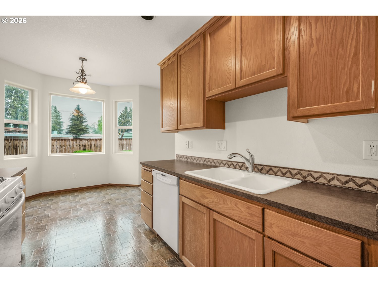 52234 Southeast Tyler Street Scappoose, OR 97056 - Photo 14 of 30 a kitchen with a sink cabinets and window