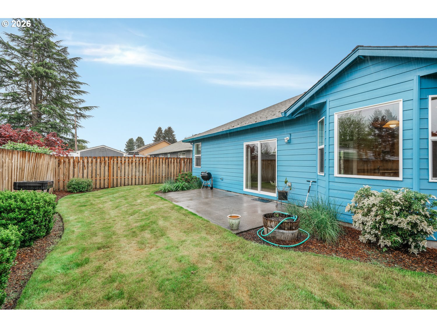 52234 Southeast Tyler Street Scappoose, OR 97056 - Photo 27 of 30 a backyard of a house with table and chairs