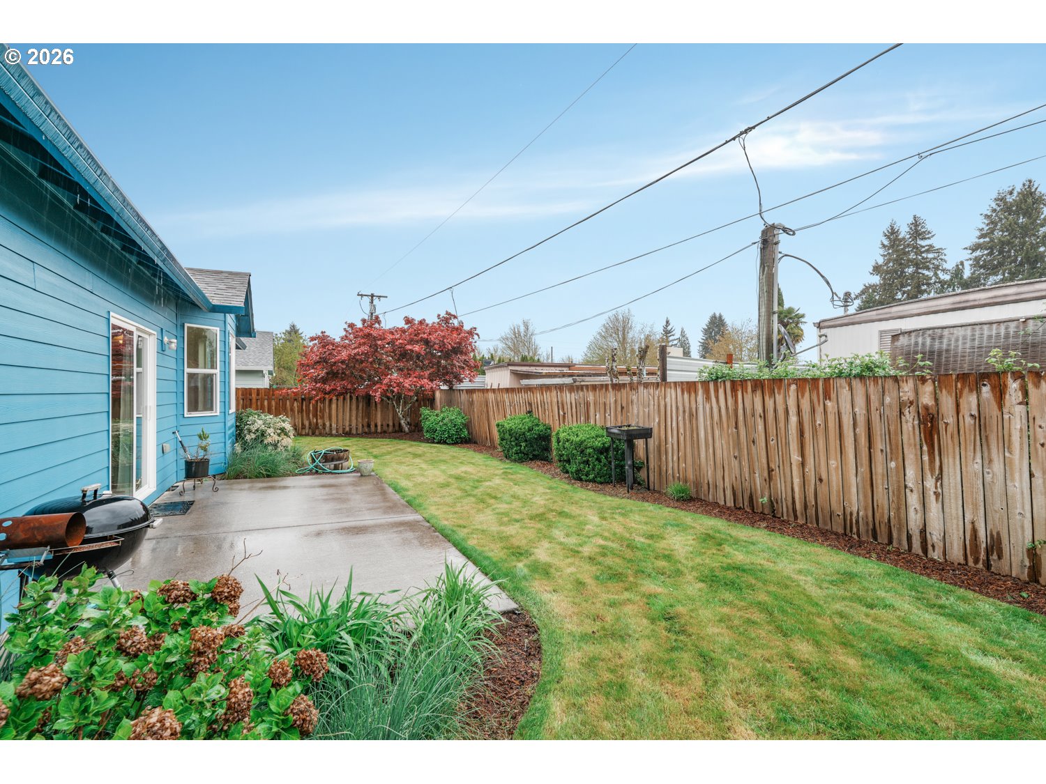 52234 Southeast Tyler Street Scappoose, OR 97056 - Photo 29 of 30 a view of a backyard with potted plants and wooden fence