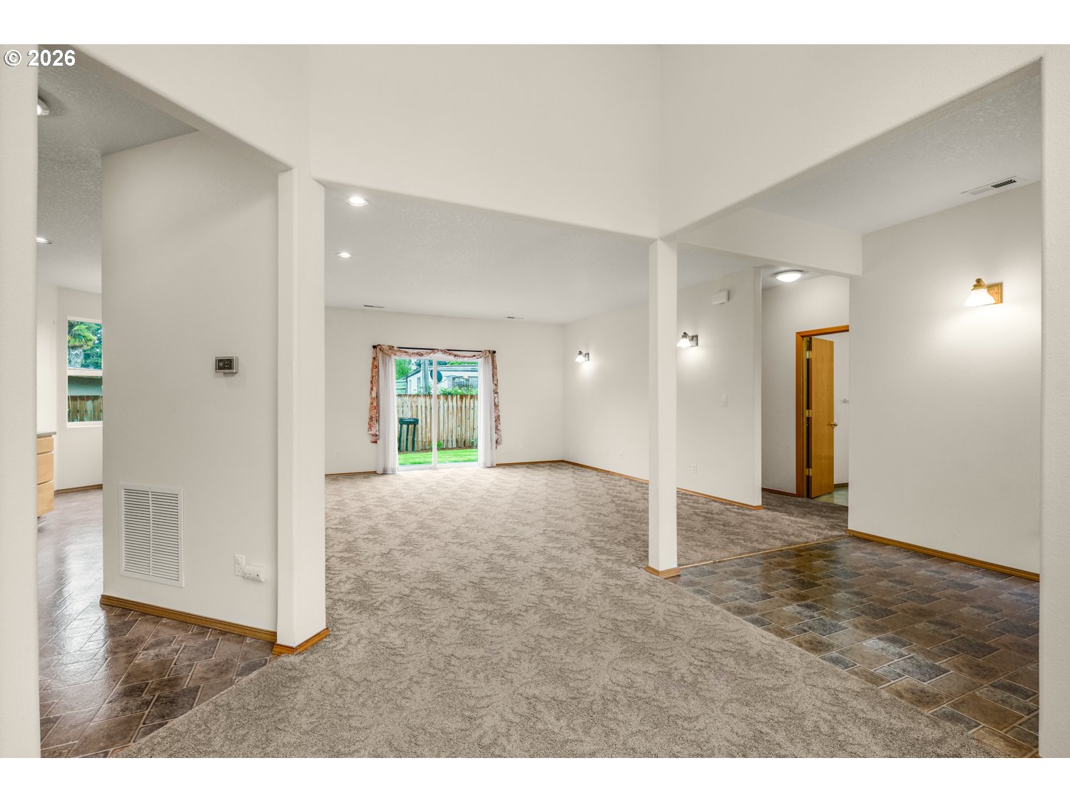 52234 Southeast Tyler Street Scappoose, OR 97056 - Photo 10 of 30 a view of a big room with wooden floor and windows