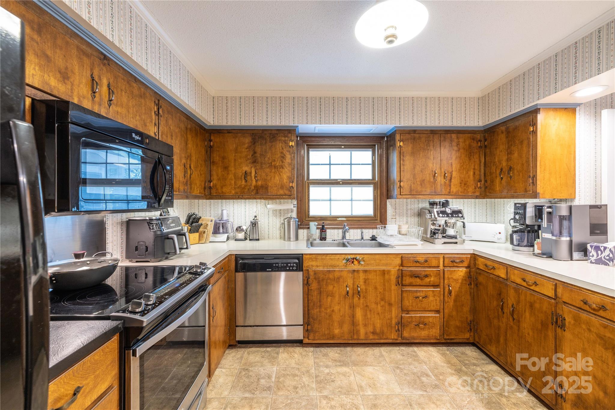 42765 Caudle Road Richfield, NC 28137 - Photo 21 of 37 a kitchen with a sink a window stainless steel appliances and cabinets