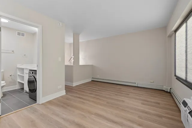 wooden floor in an empty room with a window
