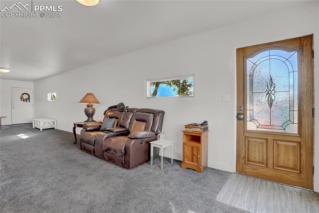 8155 North Log Road Peyton, CO 80831 - Photo 11 of 29 a living room with furniture and a window