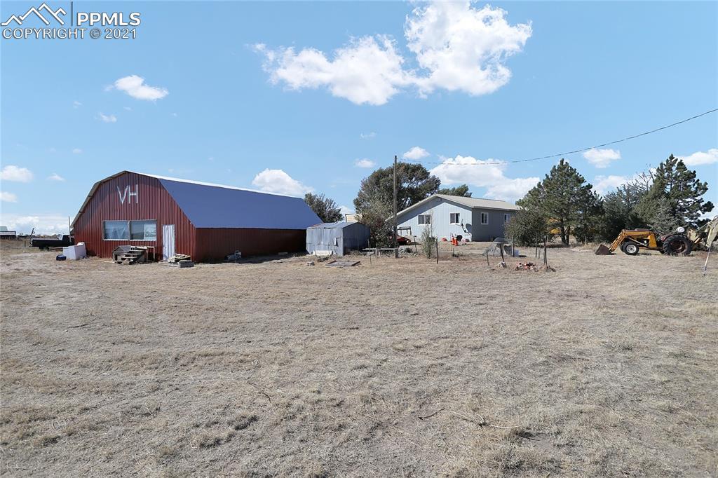 8155 North Log Road Peyton, CO 80831 - Photo 27 of 29 a view of multiple house with large trees