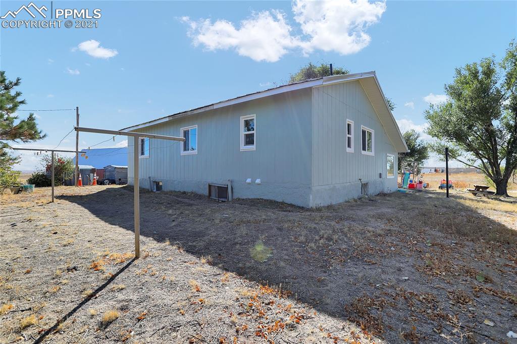 8155 North Log Road Peyton, CO 80831 - Photo 28 of 29 a view of a house with a backyard