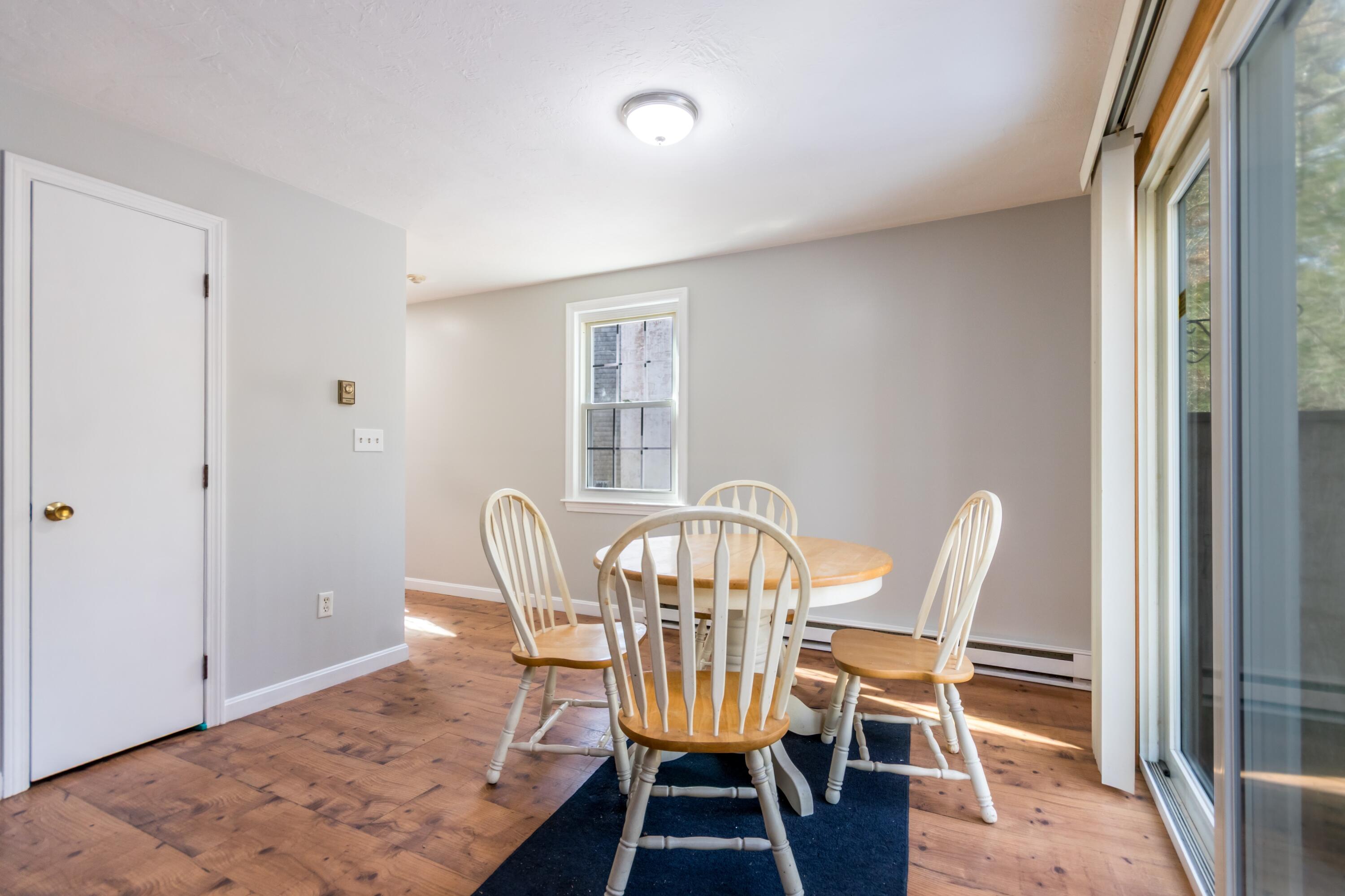 300 Falmouth Road, Unit 16A Mashpee, MA 02649 - Photo 12 of 25 a view of a dining room with furniture and wooden floor