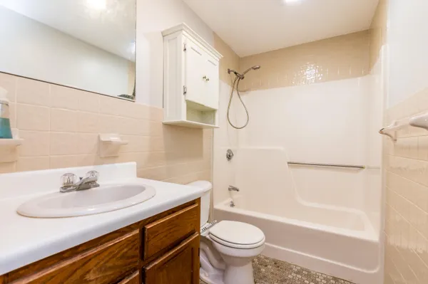 a bathroom with a sink toilet and shower